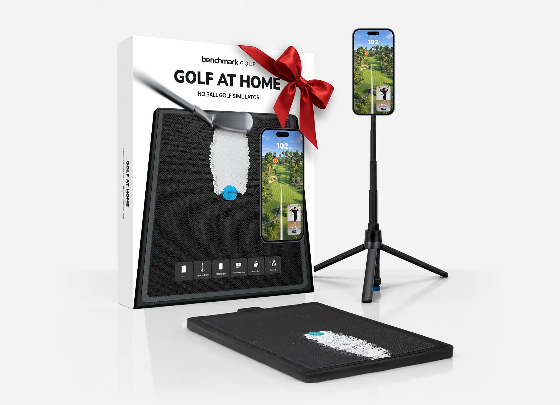 The Golf At Home box tied with a red bow, the tripod with a phone, and the mat